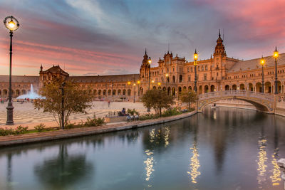 Palace against cloudy sky at sunset