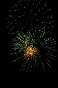 Low angle view of firework display against sky at night