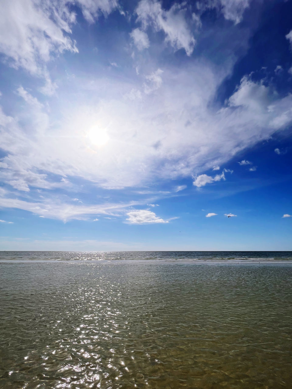 sky, horizon, water, sunlight, sea, cloud, scenics - nature, beauty in nature, reflection, ocean, nature, body of water, shore, blue, tranquility, environment, dusk, horizon over water, coast, tranquil scene, beach, land, no people, landscape, outdoors, wave, sun, morning, day, travel, seascape, sunrise, travel destinations, cloudscape, idyllic, summer, urban skyline, sunbeam