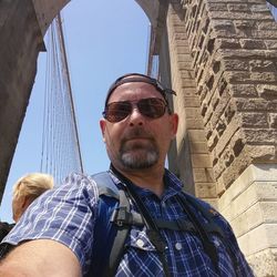 Low angle portrait of man wearing sunglasses