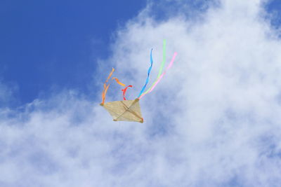 Low angle view of kite flying against sky