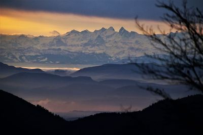 Scenic view of silhouette mountains against sky at sunset