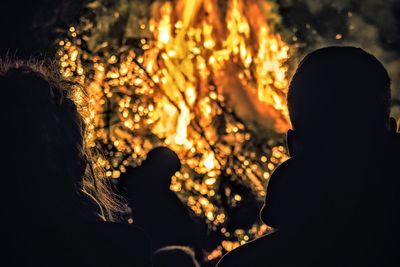 Silhouette of people standing at night