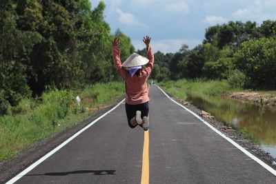 Full length of man with umbrella on road