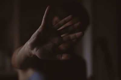 Close-up of young woman over black background