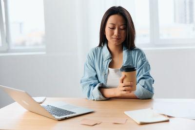 Smiling woman with coffee cup