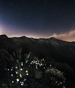 Scenic view of mountains against sky at night