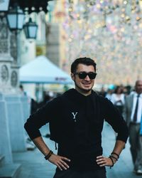 Portrait of young man wearing sunglasses standing outdoors