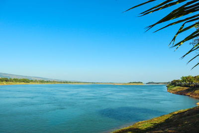 Scenic view of sea against clear blue sky