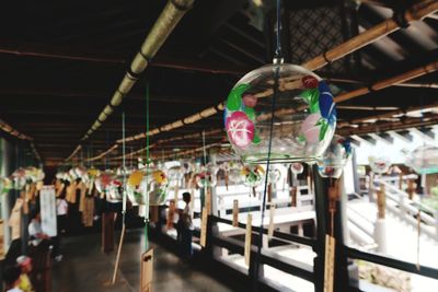 Close-up of illuminated lanterns hanging in market