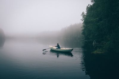 Silhouette of man in row boat