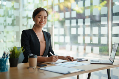 Businesswoman using laptop at office