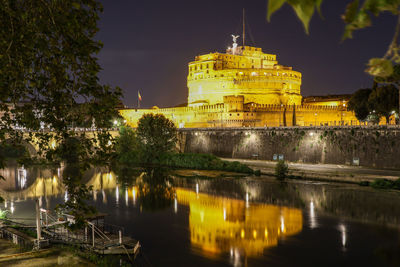 Reflection of castel sant angelo in water ar night in rome