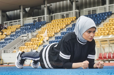 Athlete wearing hijab while exercising on sports track