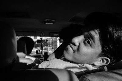 Portrait of young man sitting in car