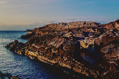 Scenic view of sea against sky at sunset