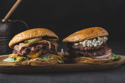 Close-up of double hamburgers on a wooden board