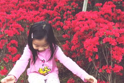 Close-up of woman holding pink flower