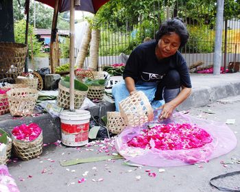 Close-up of woman holding white flowers