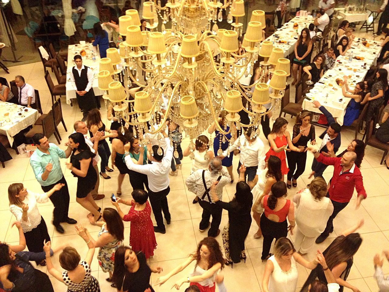 large group of people, person, lifestyles, men, high angle view, leisure activity, crowd, abundance, large group of objects, indoors, sitting, day, retail, standing, shopping, chair, wall - building feature, street