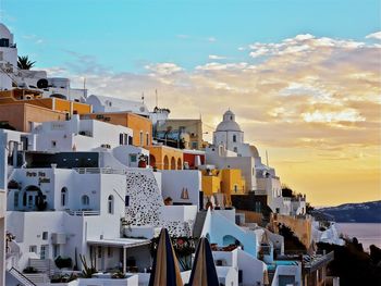 View of buildings in city at sunset