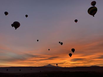 Hot air balloons flying in sky during sunset