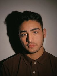 Portrait of young man against wall