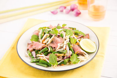 Close-up of salad and drinks on table