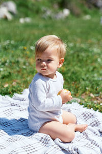 Cute baby girl sitting outdoors