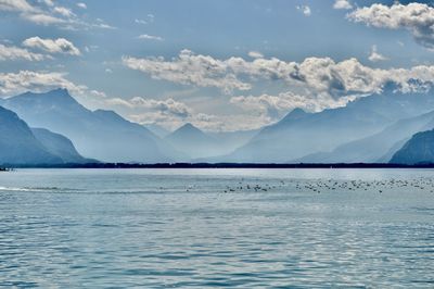 Scenic view of lake and mountains against sky