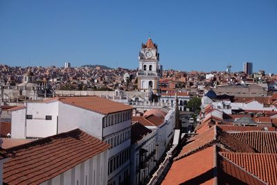 Buildings in city against clear sky