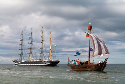 Boat sailing in sea against sky