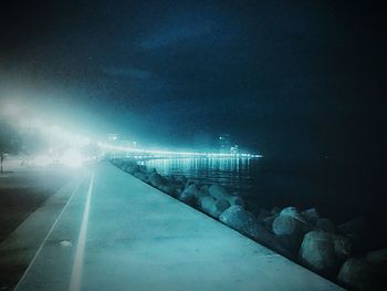 Illuminated walkway at night