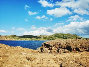 Panoramic view of rocks on shore against sky