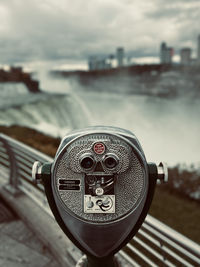 Close-up of binoculars against sky