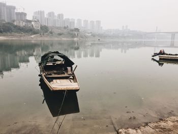 Boat in city against sky