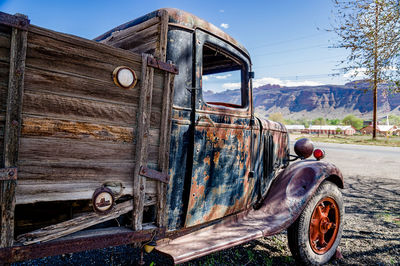 Abandoned truck on field against sky