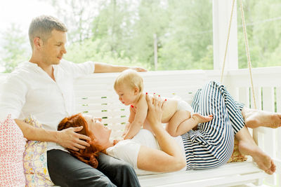 Parents with baby boy on swing