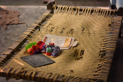 High angle view of shoes and toys on camp bed