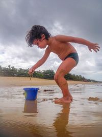 Full length of jumping jumping on swimming pool