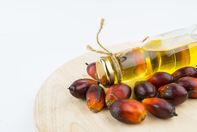 Close-up of fruits on table against white background