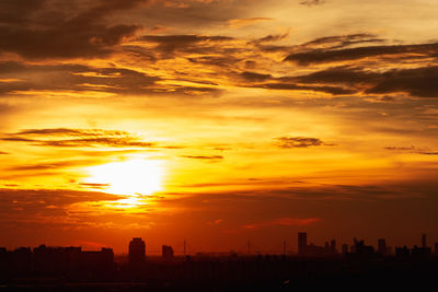 Silhouette buildings against sky during sunset