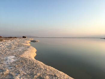 Scenic view of sea against clear sky at sunset