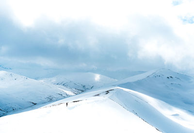 Scenic view of snow covered mountains against sky