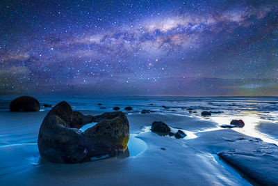 Scenic view of sea against sky at night