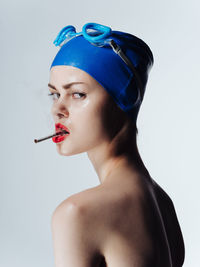 Portrait of young woman against white background