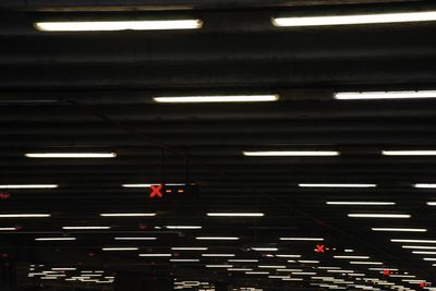 Low angle view of illuminated underground parking lot