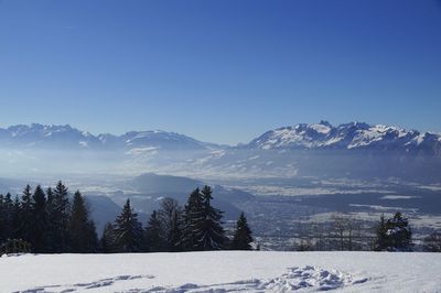 Scenic view of snow covered mountains against clear sky