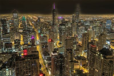 Aerial view of city lit up at night