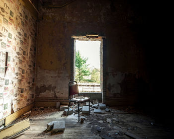Empty chair in abandoned building
